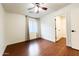 Bedroom with wood-look floors, a ceiling fan, and a closet for storage at 22755 W Yavapai St, Buckeye, AZ 85326