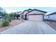 Single-story home featuring a well-maintained front yard with gravel and a two-car garage at 22755 W Yavapai St, Buckeye, AZ 85326