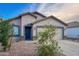 Charming single-story home featuring a well-maintained front yard with gravel and a two-car garage at 22755 W Yavapai St, Buckeye, AZ 85326