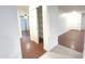 Hallway with storage closet, laminate and tile flooring, and access to the living room at 22755 W Yavapai St, Buckeye, AZ 85326