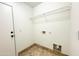 Laundry room with tile flooring, shelving, and washer/dryer hookups at 22755 W Yavapai St, Buckeye, AZ 85326