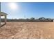 Large vacant backyard with block fencing and clear skies awaiting your landscaping touches at 22962 N 182Nd Ln, Surprise, AZ 85387
