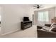 Spacious bonus room with a comfortable sofa, tv, and a modern fireplace at 22962 N 182Nd Ln, Surprise, AZ 85387