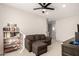 Relaxing bonus room with comfortable seating, a bookshelf, and neutral walls at 22962 N 182Nd Ln, Surprise, AZ 85387