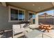 Relax in style on this covered patio with comfortable seating, outdoor grill and picnic table at 22962 N 182Nd Ln, Surprise, AZ 85387