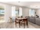 This cozy dining area features natural light, a modern table, and a view of the outdoor patio at 22962 N 182Nd Ln, Surprise, AZ 85387