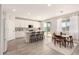 Bright kitchen features a breakfast bar, stainless steel appliances, white cabinetry, and adjacent dining area at 22962 N 182Nd Ln, Surprise, AZ 85387