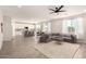 Open-concept living space with ample seating, neutral decor, direct access to the kitchen, and modern lighting at 22962 N 182Nd Ln, Surprise, AZ 85387