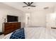 Bright main bedroom boasts an inviting king bed with patterned throws, side tables, dresser, and plush bedding at 22962 N 182Nd Ln, Surprise, AZ 85387