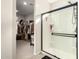 The bright main bathroom includes a glass enclosed shower with chrome fixtures and a walk-in closet at 22962 N 182Nd Ln, Surprise, AZ 85387
