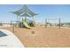 Community playground with various play structures for children at 24129 W Bowker St, Buckeye, AZ 85326