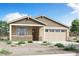 Charming single-story home with a two-car garage, stone accents, and low maintenance landscaping at 24183 W Agora Ln, Buckeye, AZ 85326
