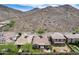 Beautiful aerial perspective reveals a home with a landscaped yard and mountain views in the distance at 29214 N 19Th Ln, Phoenix, AZ 85085
