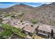 Aerial view showcases a neighborhood against a backdrop of desert mountains and natural terrain at 29214 N 19Th Ln, Phoenix, AZ 85085