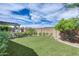 Landscaped backyard featuring artificial turf, colorful plants, and blue skies at 29214 N 19Th Ln, Phoenix, AZ 85085