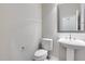 Powder room with pedestal sink, decorative mirror, and neutral-toned walls at 29214 N 19Th Ln, Phoenix, AZ 85085