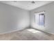 Neutral bedroom featuring a window with bright sunlight shining through at 29214 N 19Th Ln, Phoenix, AZ 85085