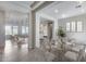 Bright dining room with a modern glass table and seating for six, with views into multiple living spaces at 29214 N 19Th Ln, Phoenix, AZ 85085
