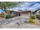 Inviting single-Gathering home boasts a well-manicured yard, mature tree, and a spacious three-car garage at 29214 N 19Th Ln, Phoenix, AZ 85085