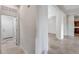 Clean, bright hallway with tiled flooring leads to various rooms in the house at 29214 N 19Th Ln, Phoenix, AZ 85085