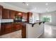 Modern kitchen features sleek granite countertops, rich wood cabinetry, and stainless steel appliances at 29214 N 19Th Ln, Phoenix, AZ 85085