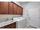 Functional laundry room with sink, ample cabinetry, and a side-by-side washer and dryer at 29214 N 19Th Ln, Phoenix, AZ 85085