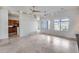 Open-concept living room featuring tile floors, fan, and bright sunlight at 29214 N 19Th Ln, Phoenix, AZ 85085