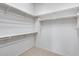 A well-organized walk-in closet providing ample shelving and storage space for clothes and accessories at 29214 N 19Th Ln, Phoenix, AZ 85085