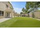 Spacious backyard with artificial turf, a covered patio and seating for entertaining at 3349 E Flamingo Ct, Gilbert, AZ 85297
