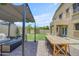 Inviting backyard patio with a cozy seating area, dining space, and well-manicured lawn at 3349 E Flamingo Ct, Gilbert, AZ 85297