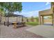 Beautiful backyard with a cozy patio, a dining area, and lush artificial grass, perfect for relaxation at 3349 E Flamingo Ct, Gilbert, AZ 85297