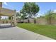 Expansive backyard with lush artificial grass, covered patio and privacy fence at 3349 E Flamingo Ct, Gilbert, AZ 85297
