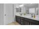 Bathroom with double sink vanity with framed mirrors, and lots of natural light at 3349 E Flamingo Ct, Gilbert, AZ 85297