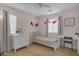 Inviting bedroom with a white dresser, a desk, and a cozy bed, filled with natural light at 3349 E Flamingo Ct, Gilbert, AZ 85297
