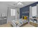 Bright bedroom features stylish decor and a cheerful design with a vibrant accent wall and natural light at 3349 E Flamingo Ct, Gilbert, AZ 85297