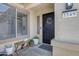Front entryway featuring a black security door, welcome mat, and decorative plants at 3349 E Flamingo Ct, Gilbert, AZ 85297