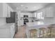 Modern kitchen with stainless steel appliances, white cabinets, and a breakfast bar at 3349 E Flamingo Ct, Gilbert, AZ 85297