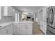 Open-concept kitchen with white cabinets and stainless steel appliances, seamlessly connected to the living area at 3349 E Flamingo Ct, Gilbert, AZ 85297
