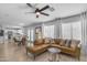 Open-concept living room featuring a leather sectional sofa and views into the kitchen area at 3349 E Flamingo Ct, Gilbert, AZ 85297