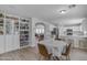 Open floor plan showing living room, dining table and view to the kitchen with bookcase at 3349 E Flamingo Ct, Gilbert, AZ 85297
