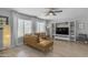 Cozy living room with a tan sectional couch, large windows, and stylish decor at 3349 E Flamingo Ct, Gilbert, AZ 85297