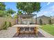 Relaxing patio with a dining table set and a comfortable seating area under a stylish pergola at 3349 E Flamingo Ct, Gilbert, AZ 85297