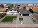 Aerial view of a modern home with a manicured lawn and elegant gray brick driveway, showcasing its prime location at 3413 N 87Th Pl, Scottsdale, AZ 85251