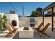 Inviting backyard featuring an outdoor kitchen, fire pit with seating, and stylish travertine pavers at 3413 N 87Th Pl, Scottsdale, AZ 85251