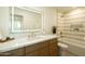 Bright bathroom featuring a well-lit mirror, double vanity, and a shower-tub combination at 3413 N 87Th Pl, Scottsdale, AZ 85251