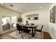 Elegant dining room with a wooden table, modern chairs, and a sliding glass door, perfect for Gathering meals at 3413 N 87Th Pl, Scottsdale, AZ 85251