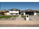 Beautiful two-story home featuring a manicured lawn and stylish gray brick walkway, creating a welcoming entrance at 3413 N 87Th Pl, Scottsdale, AZ 85251