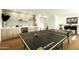 Spacious game room featuring a modern bar area and ping pong table, perfect for entertaining guests at 3413 N 87Th Pl, Scottsdale, AZ 85251