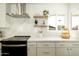 Close-up of a kitchen featuring white cabinets, modern appliances, and sleek countertops with stylish decor at 3413 N 87Th Pl, Scottsdale, AZ 85251