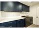 Well-organized laundry room with ample cabinet space, washer, and dryer at 3413 N 87Th Pl, Scottsdale, AZ 85251